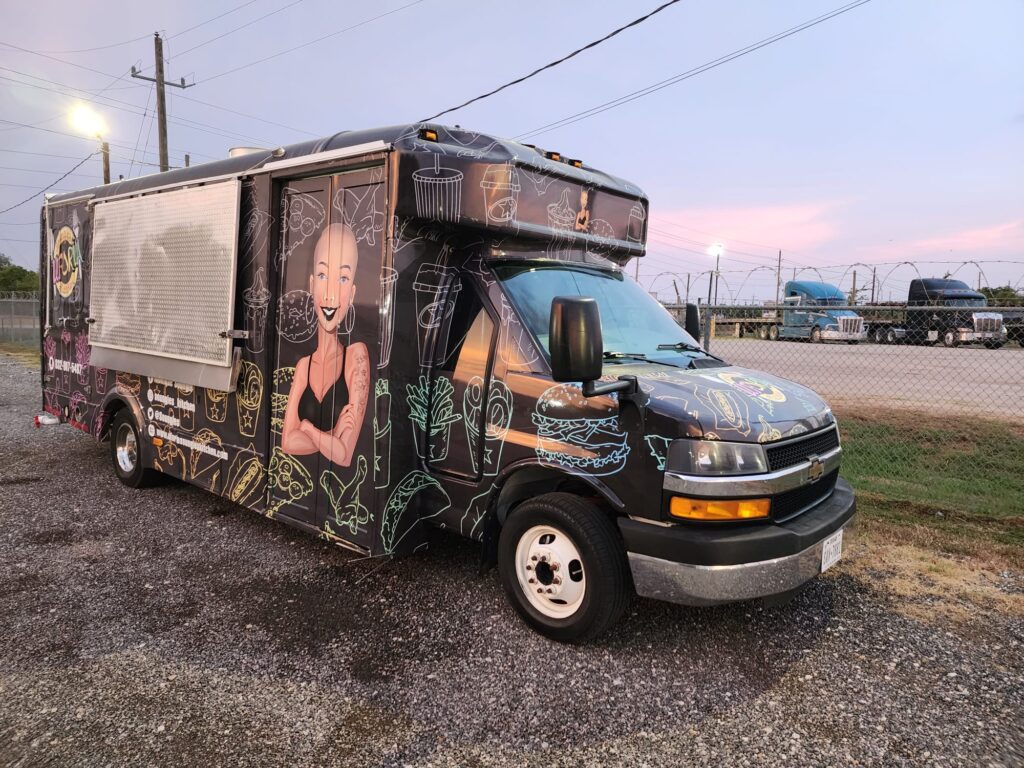 Dark-colored food truck seen from outside.