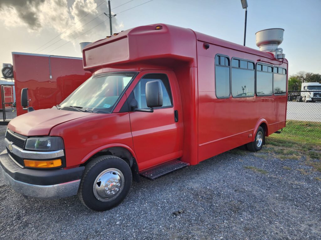 Red food truck seen from outside.